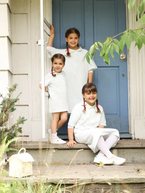 Three sisters on the steps of a blue-door cottage, outdoor photography by Photoholic, Rockland County NY